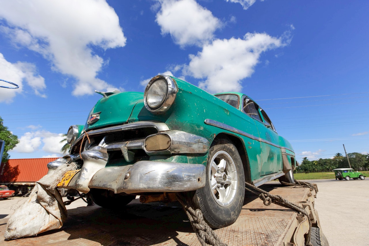 Green Classic Car on a Truck | Veteran Car Donations