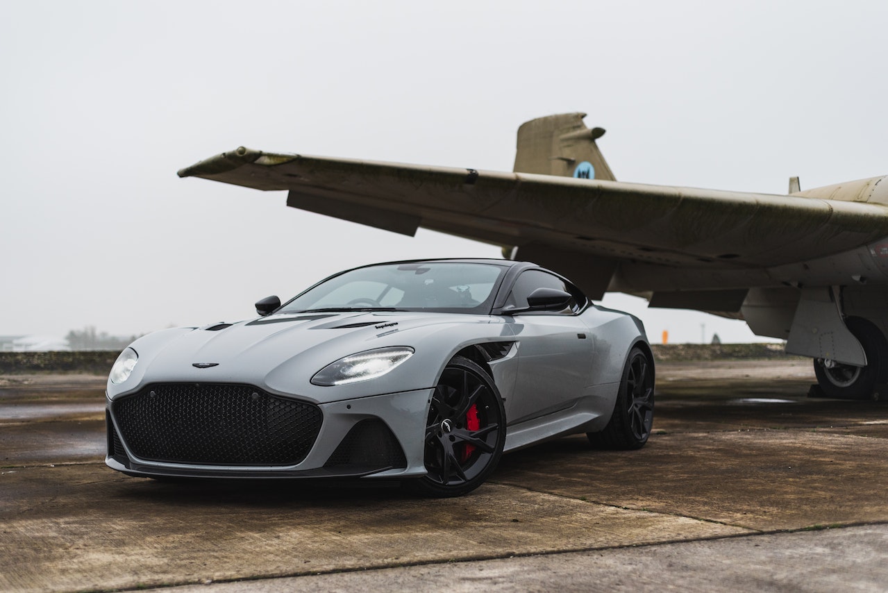 A Car Parked Beside airplane | Veteran Car Donations