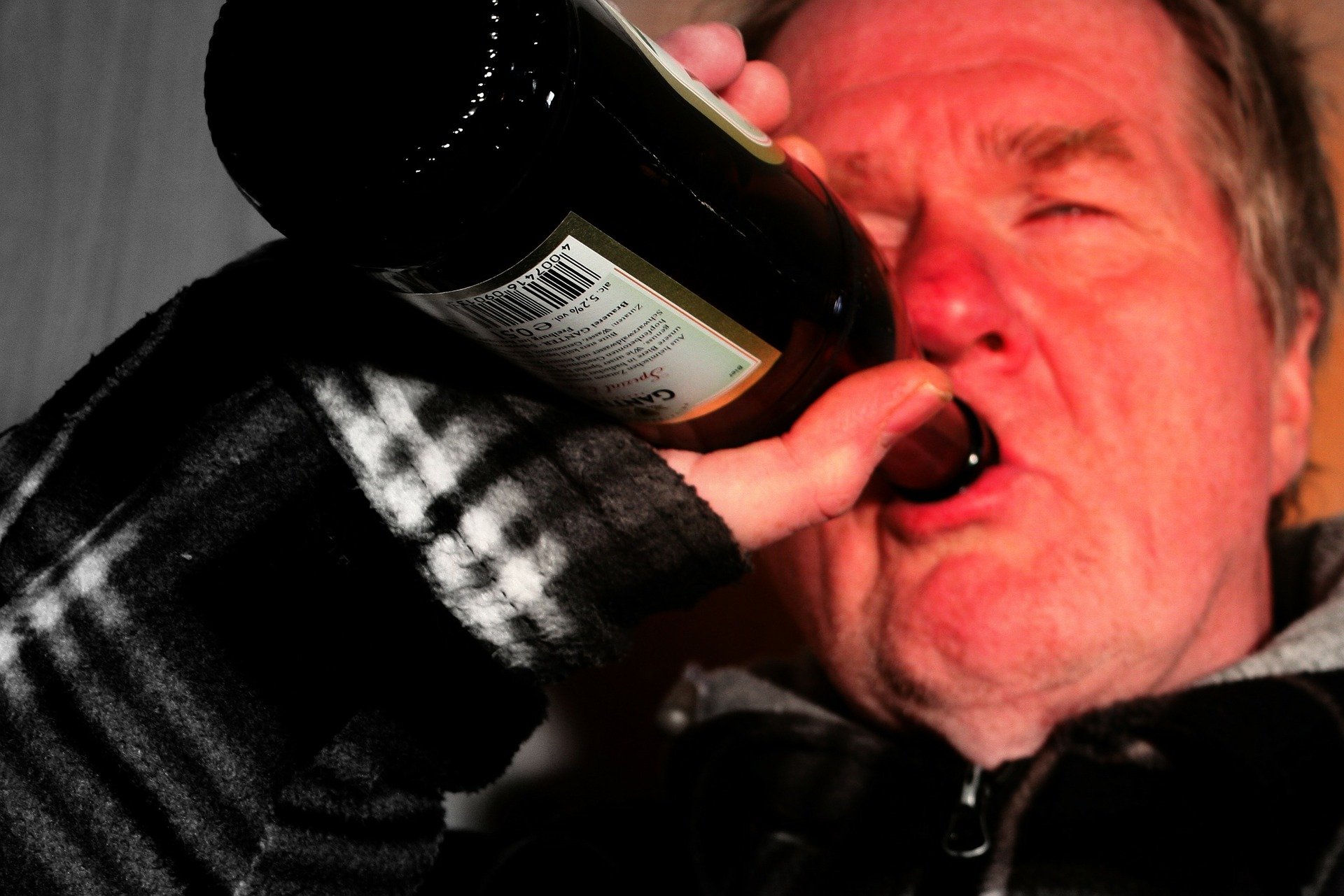 Man Drinking a Bottle of Beer - VeteranCarDonations.org