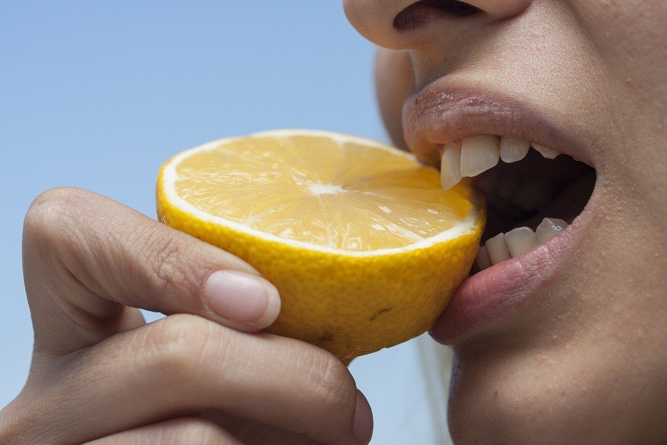 Girl Eating Lemon - VeteranCarDonations.org