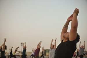 Military Men and Woman Doing Yoga - VeteranCarDonations.org