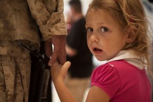 Girl Holding Soldier's Hand | Veteran Car Donations