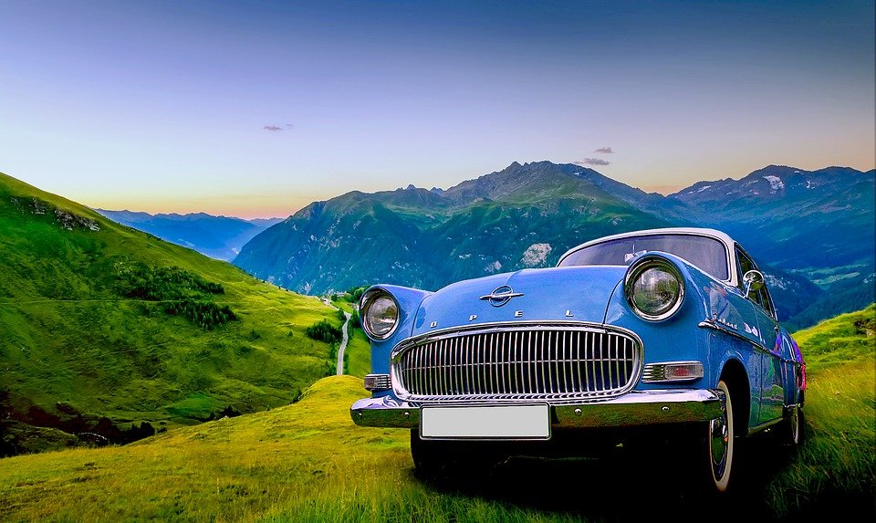 Blue Oldtimer Car in the Mountains - VeteranCarDonations.org