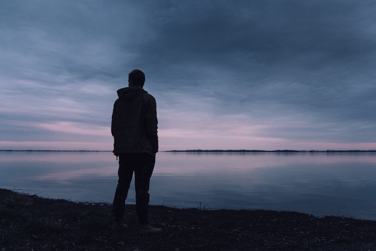 Person Standing Near Lake | Veteran Car Donations
