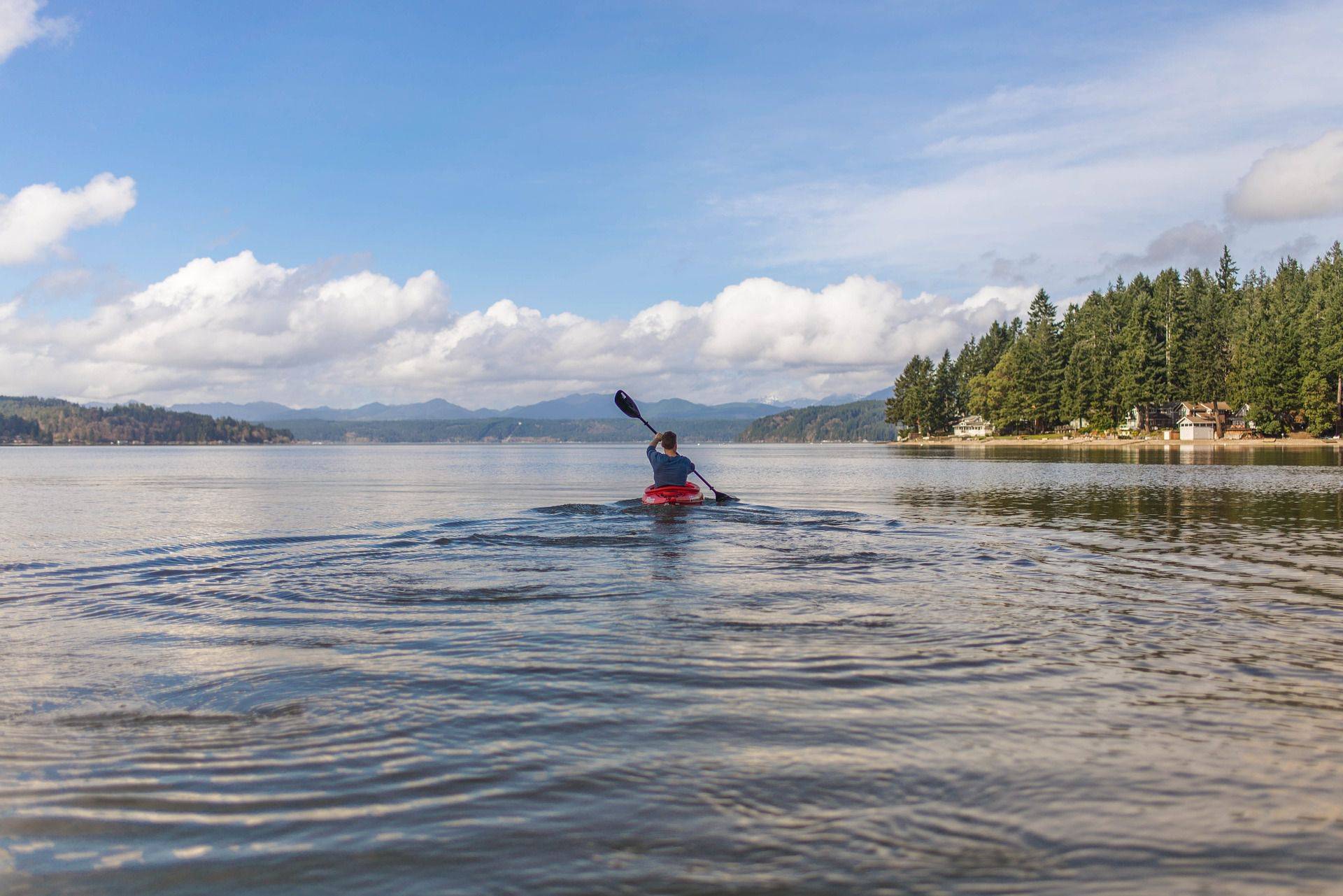 Man Kayaking on a Lake | Veteran Car Donations