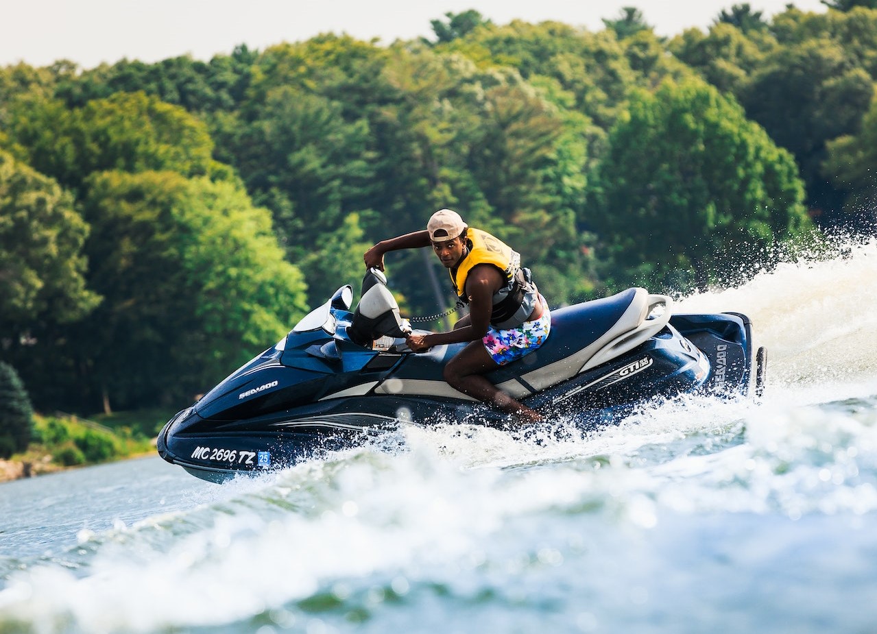 Man Using a Jet Ski in the Lake | Veteran Car Donations
