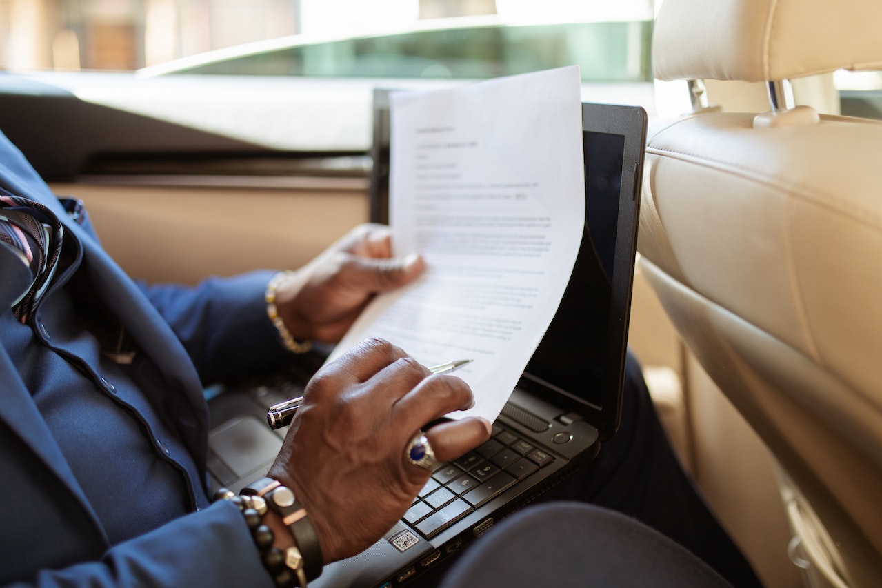 Person in Blue Long Sleeve Shirt Using Black Laptop Computer | Veteran Car Donations