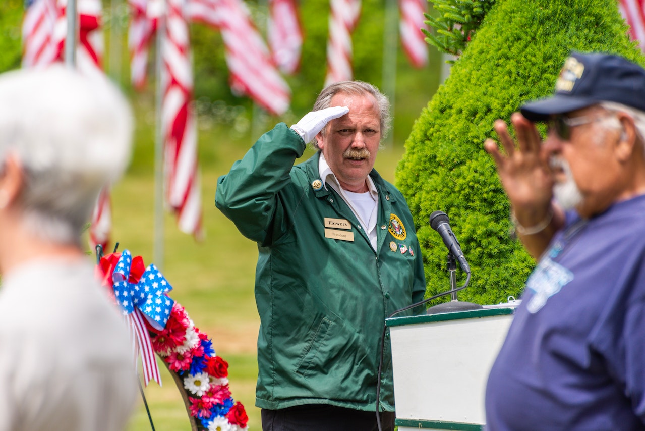 Men Making Gesture Showing Respect at Memorial Service | Veteran Car Donations
