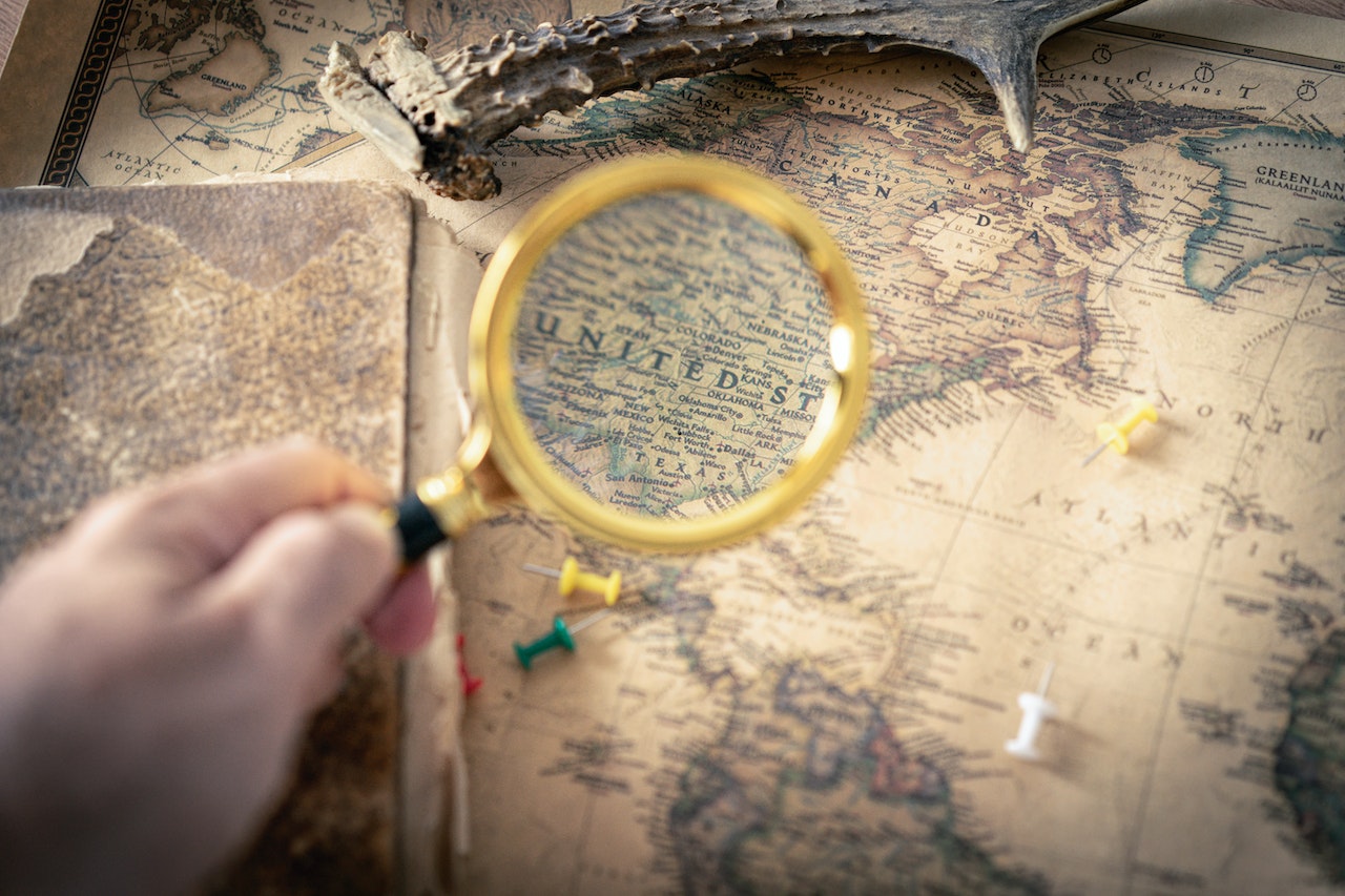 Person Holding Magnifying Glass | Veteran Car Donations