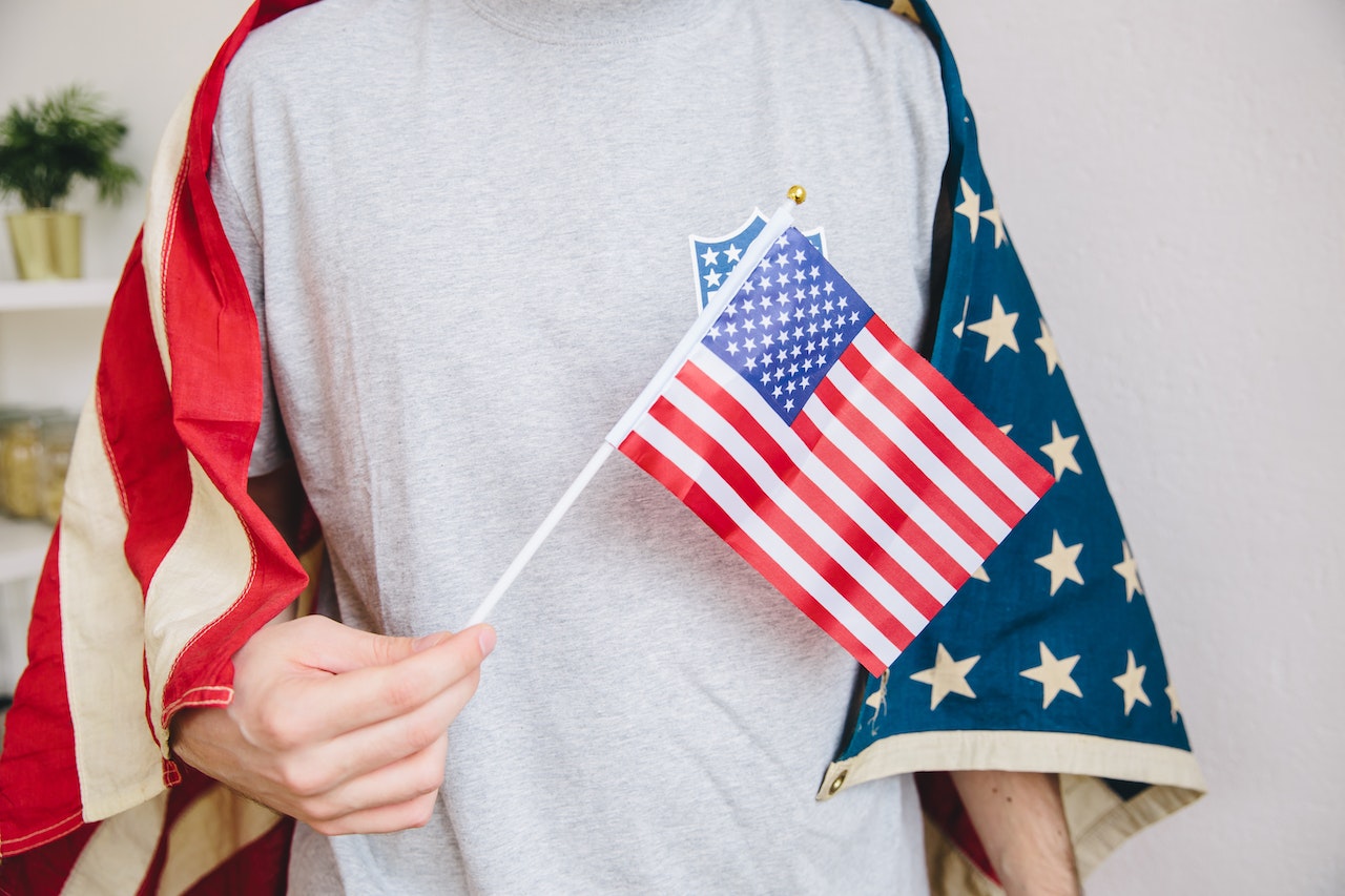 Person Holding US Flag | Veteran Car Donations

