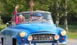 Couple Driving a Blue Oldtimer Car | Veteran Car Donations
