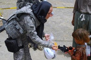 Military Woman Helping a Kid
