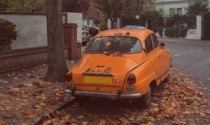 Orange Oldtimer Car Parked in the Street | Veteran Car Donations