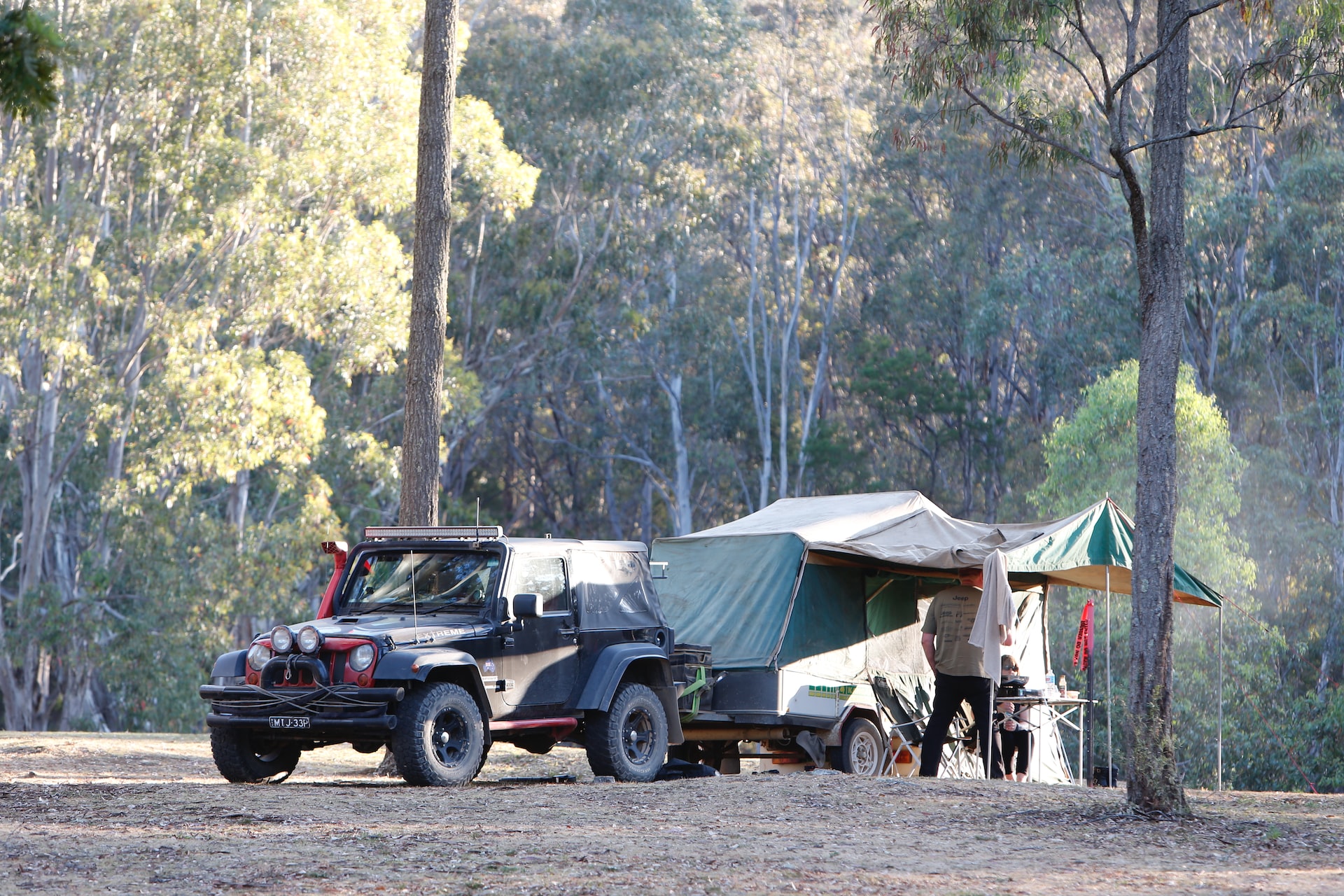 Pop up camper parked with black SUV | Veteran Car Donations