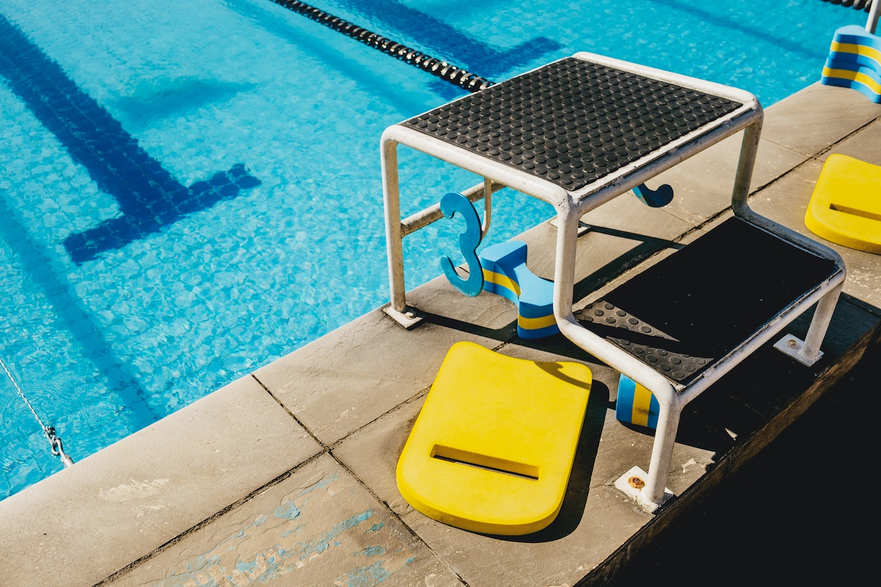 Diving board in swimming pool with blue water | Veteran Car Donations