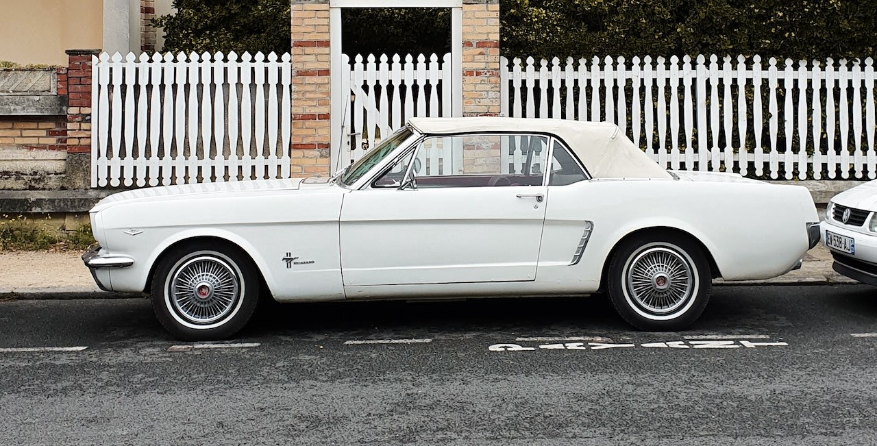 Photo of a Parked White Coupe on The Street | Veteran Car Donations
