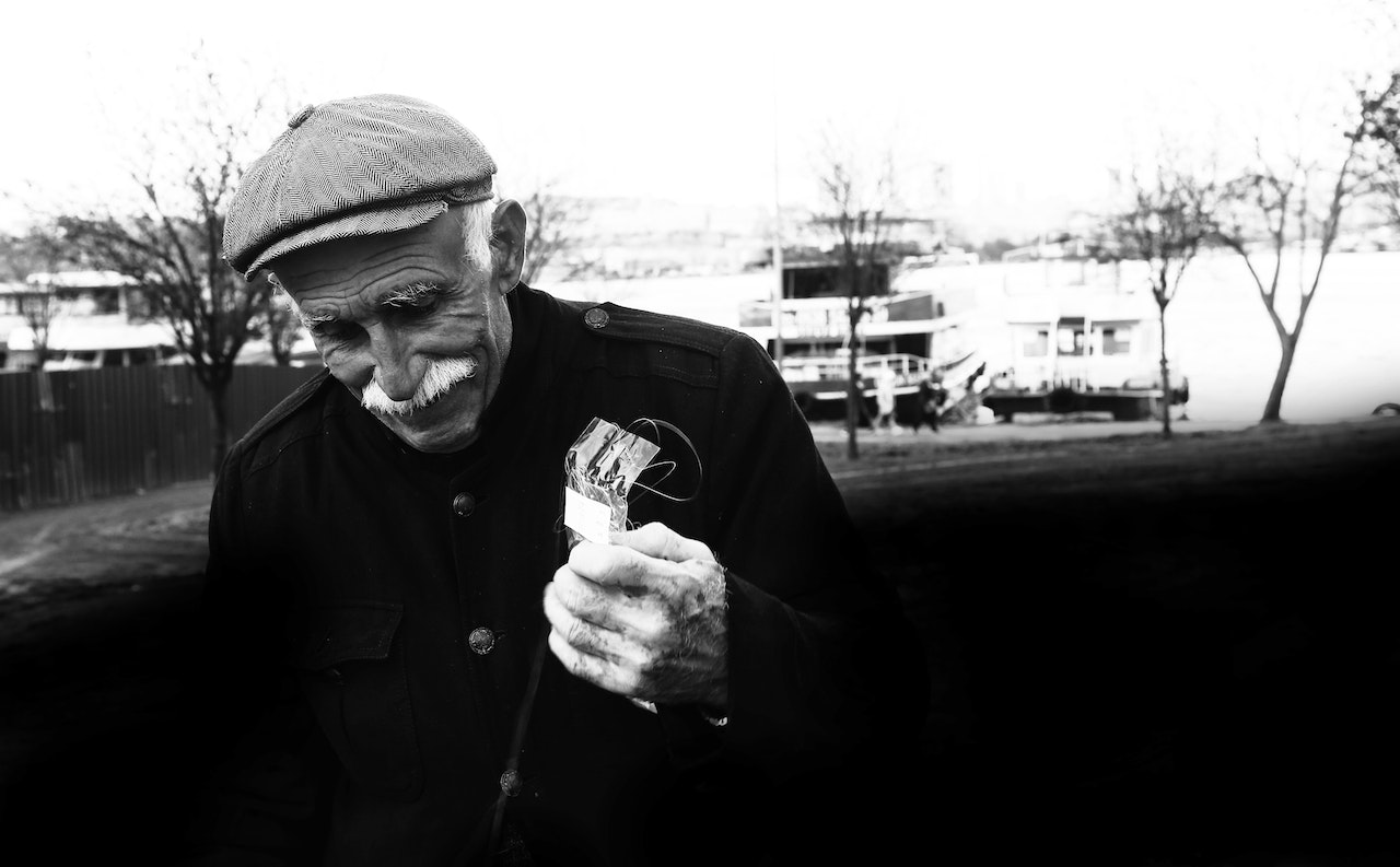 A Man in Black Jacket Wearing a Cap | Veteran Car Donations
