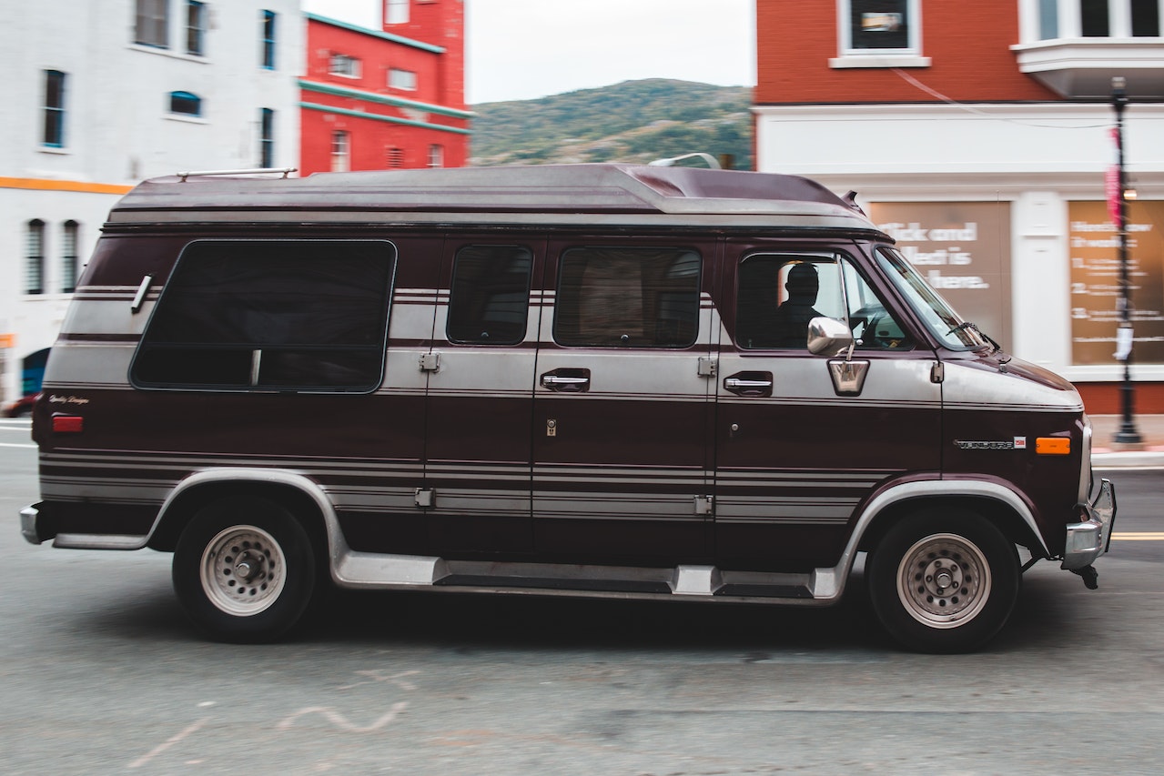 Black minivan on asphalt road | Veteran Car Donations