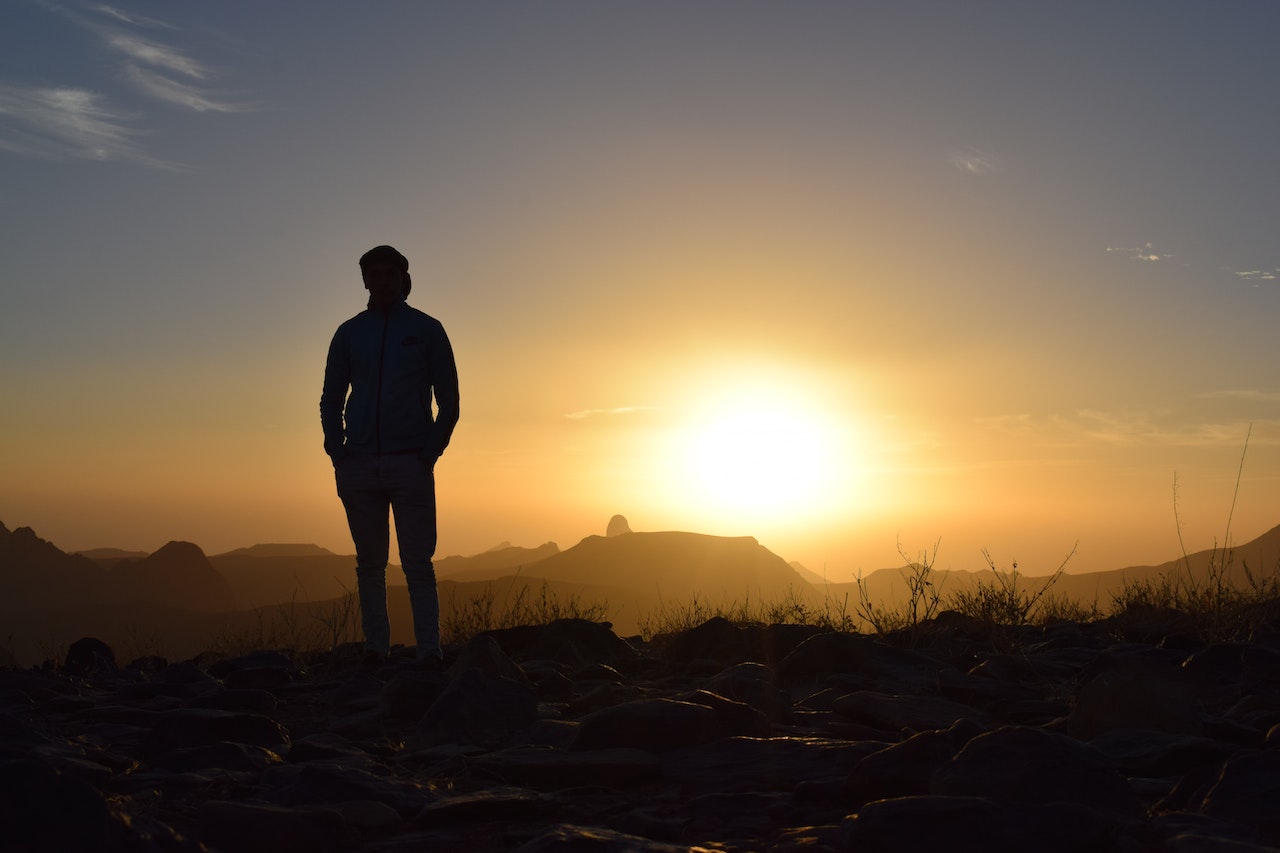 Person Taking Photo in Sunset | Veteran Car Donations
