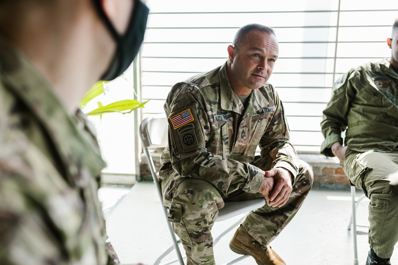 Photo of Soldiers Sitting on Folding Chairs | Veteran Car Donations
