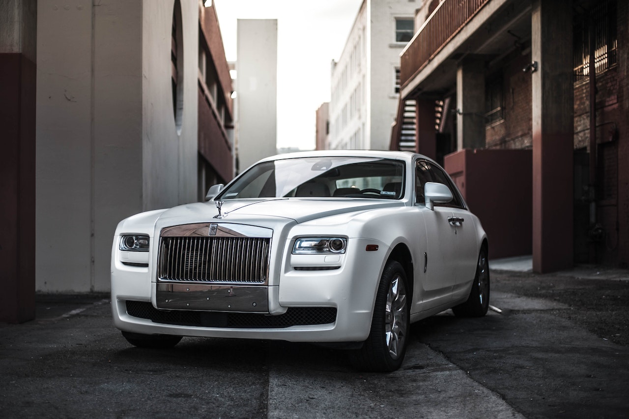 Photo of White Rolls Royce Ghost Parked in an Alley | Veteran Car Donations