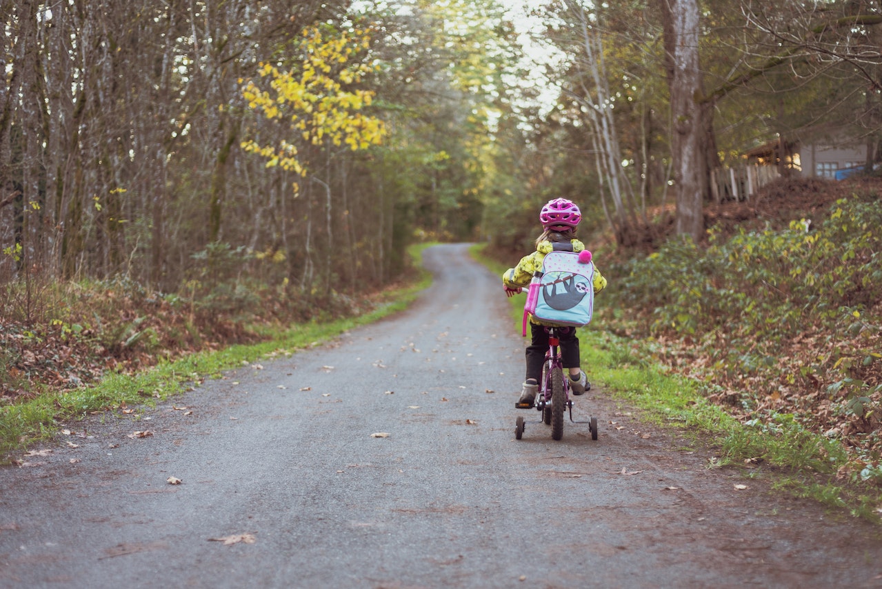 Toddler Riding Bicycle on Road | Veteran Car Donations