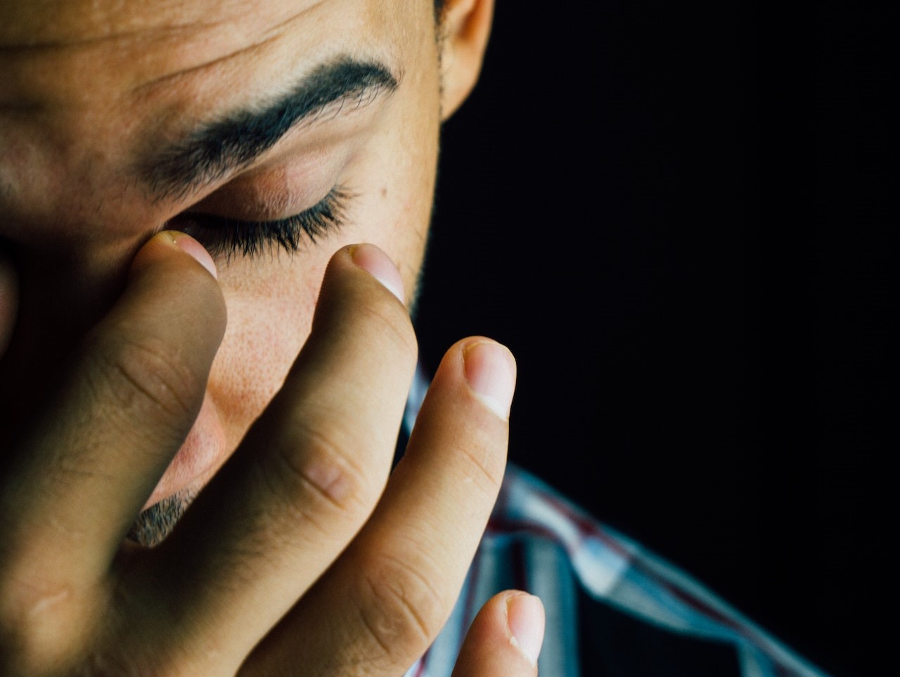 Man Pinching Nose Close-up Photo | Veteran Car Donations