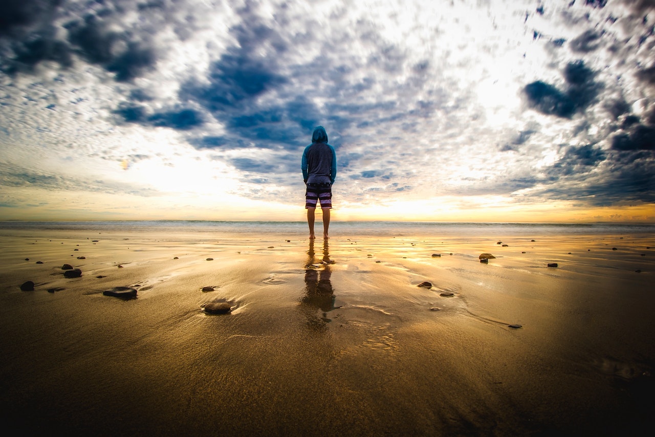 Person Standing on Sand | Veteran Car Donations
