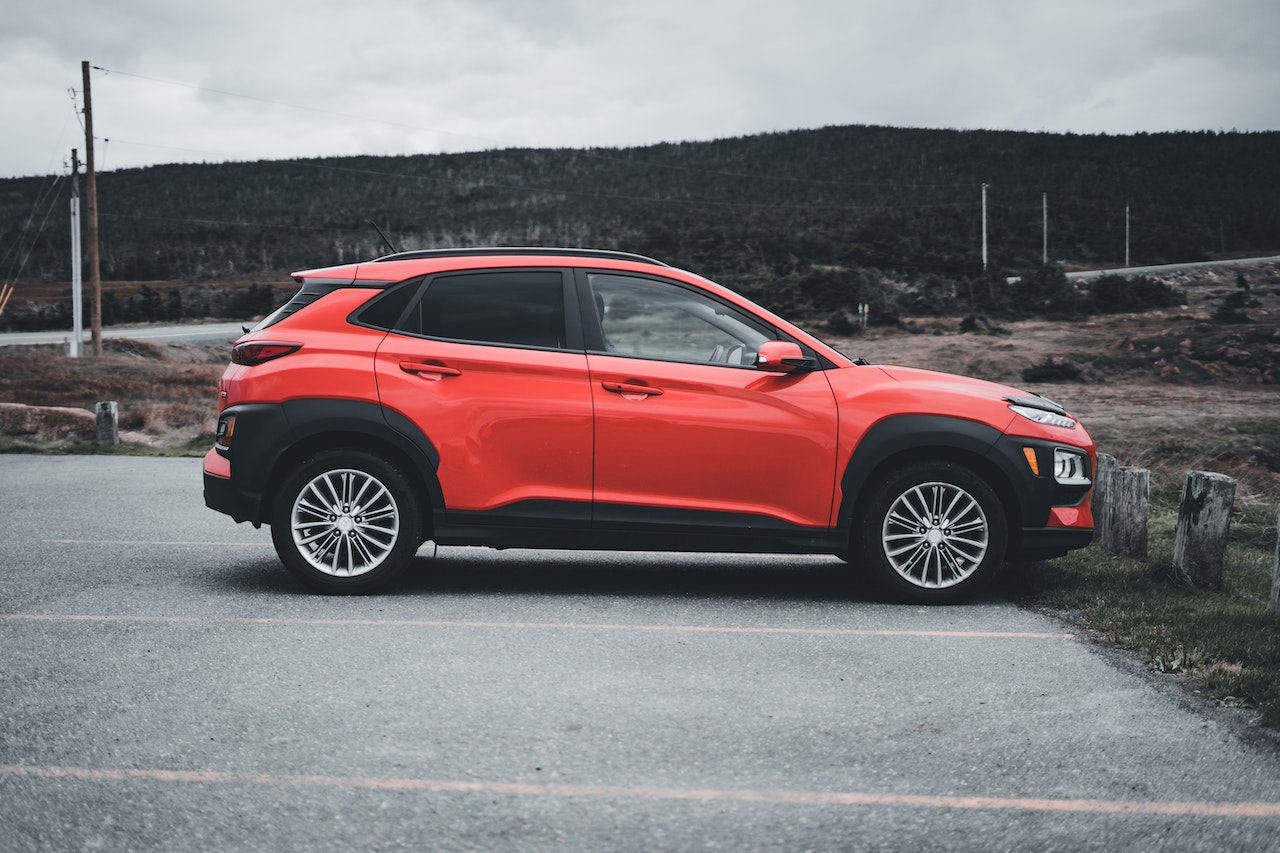 Side View of a Parked Red Vehicle | Veteran Car Donations