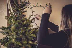 Woman Preparing Christmas Lights for Holidays | Veteran Car Donations