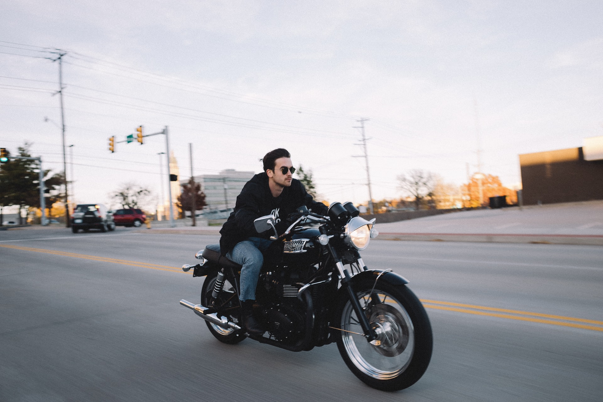 man riding cruiser motorcycle at the road during day photo | Veteran Car Donations