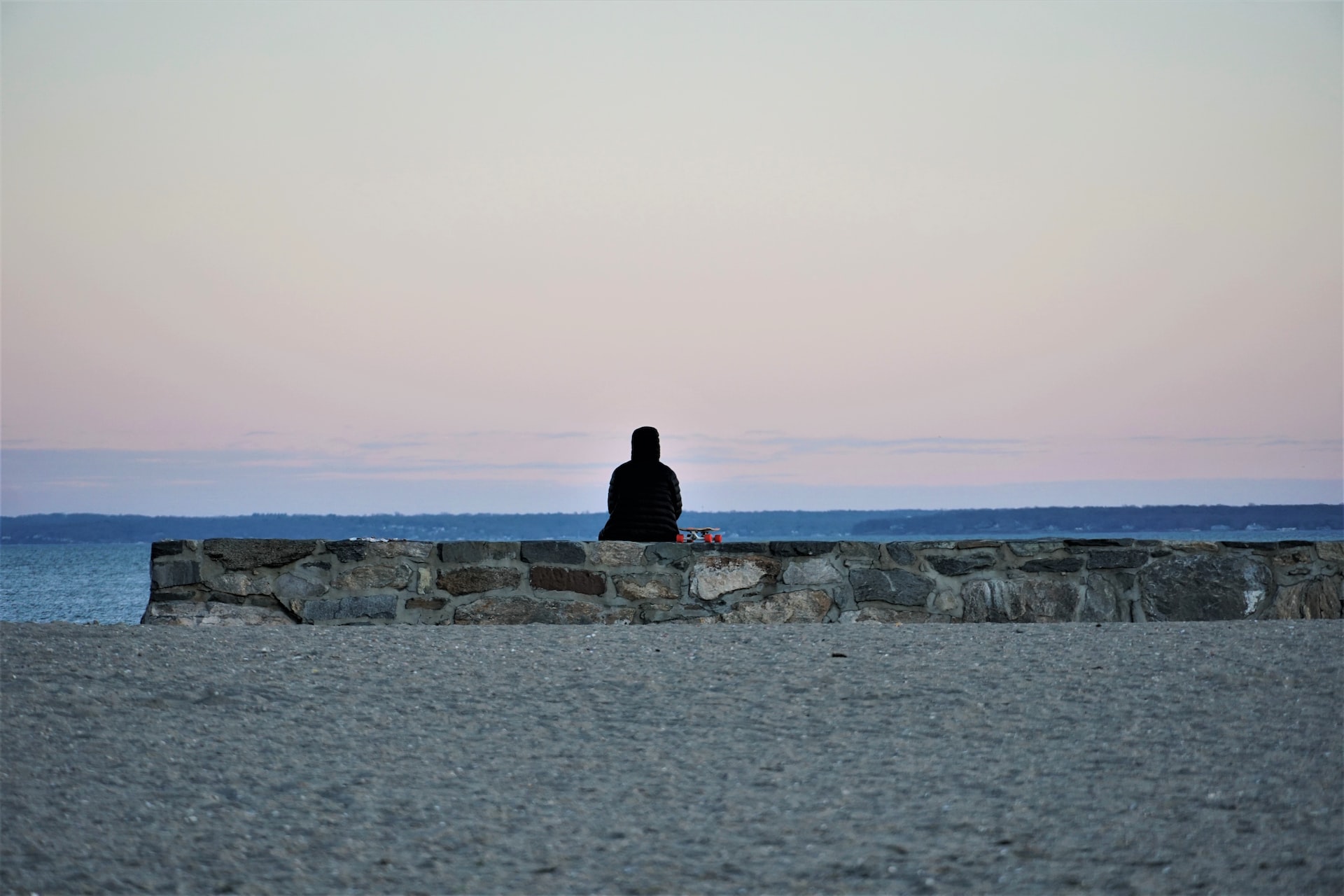 Man sitting on sea wall | Veteran Car Donations