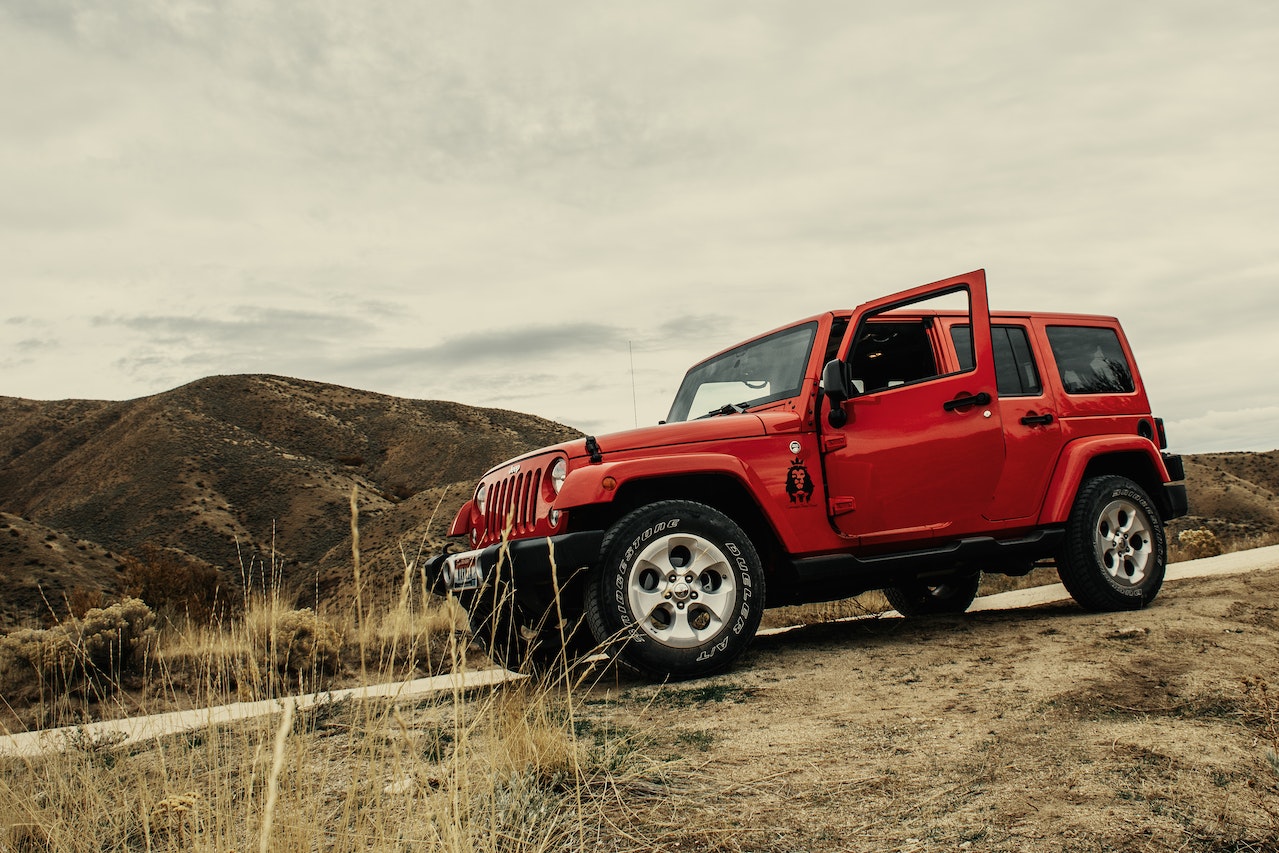 Photo of Red SUV On Dirt Road | Veteran Car Donations