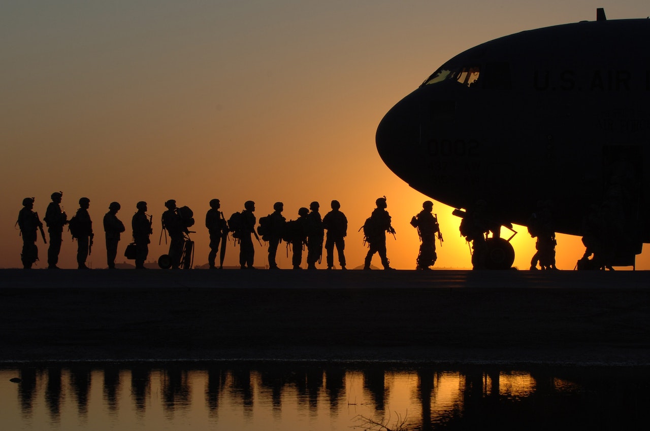 Soldiers in Line to Get in a Plane | Veteran Car Donations
