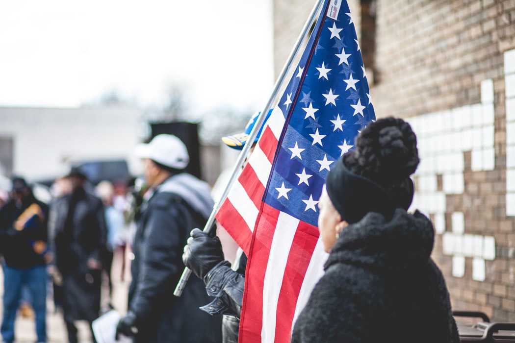 Man Waving the US Flag | Veteran Car Donations