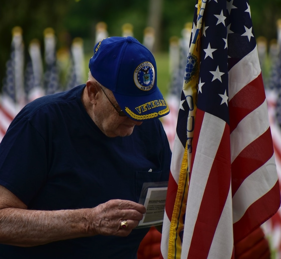 Elderly Veteran Beside American Flag | Veteran Car Donations