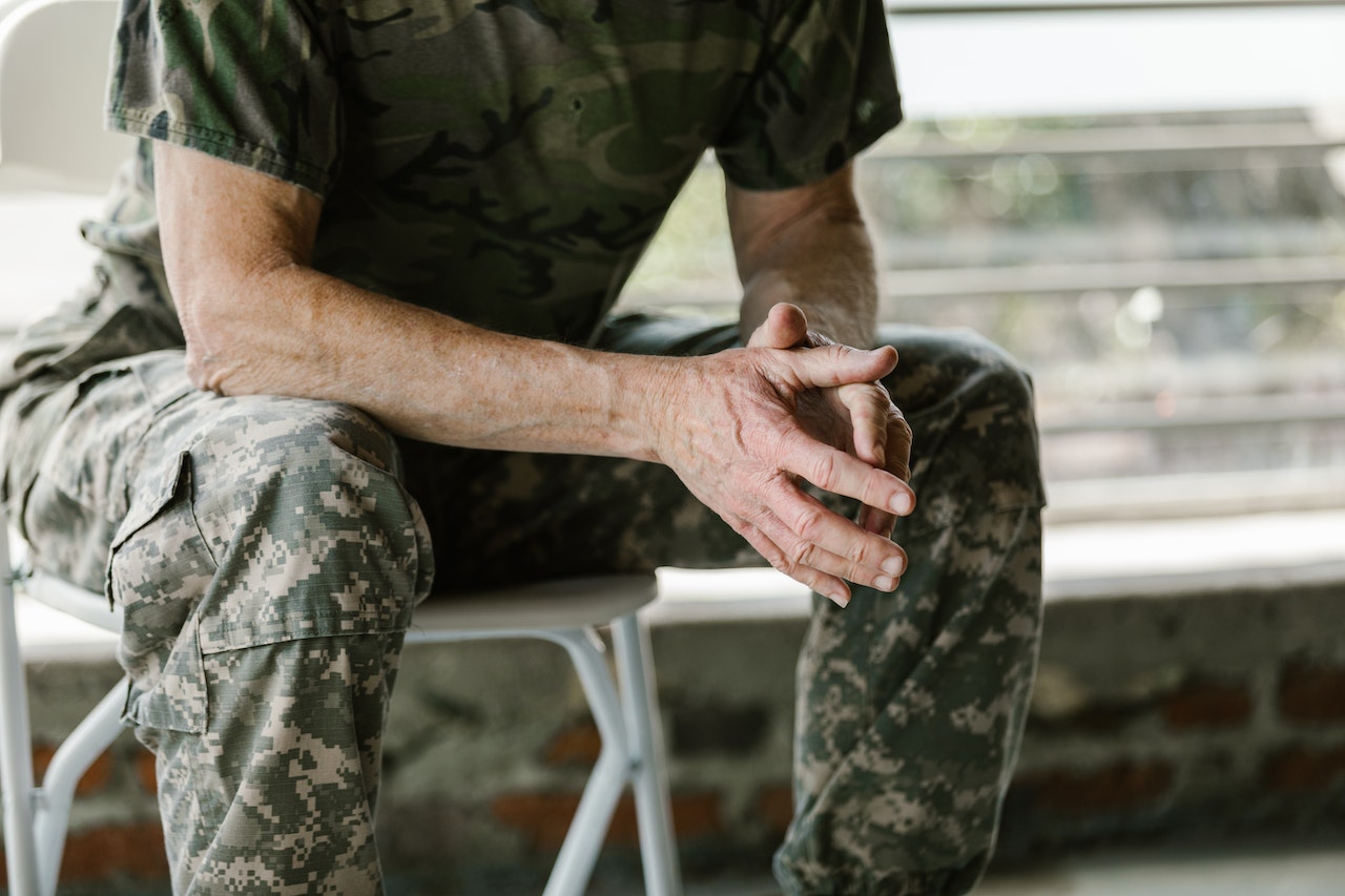 Person in Green and Brown Camouflage Shirt | Veteran Car Donations
