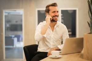 Man Taking a Phone Call At Work | Veteran Car Donations