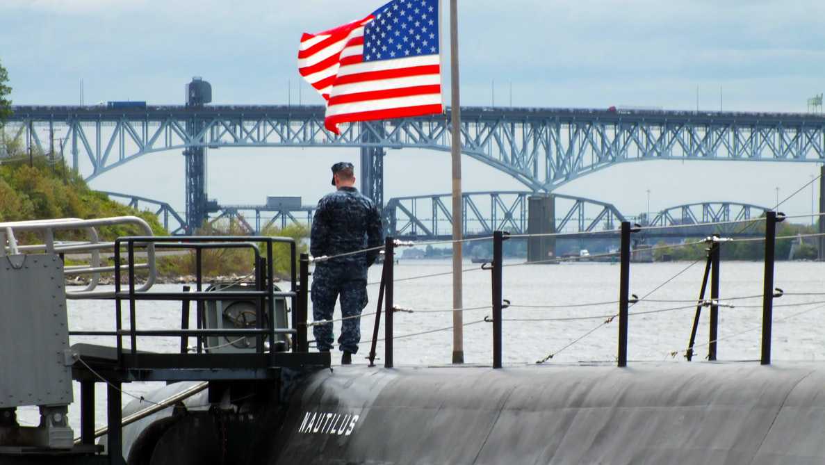 Military Man Standing on a Submarine | Veteran Car Donations