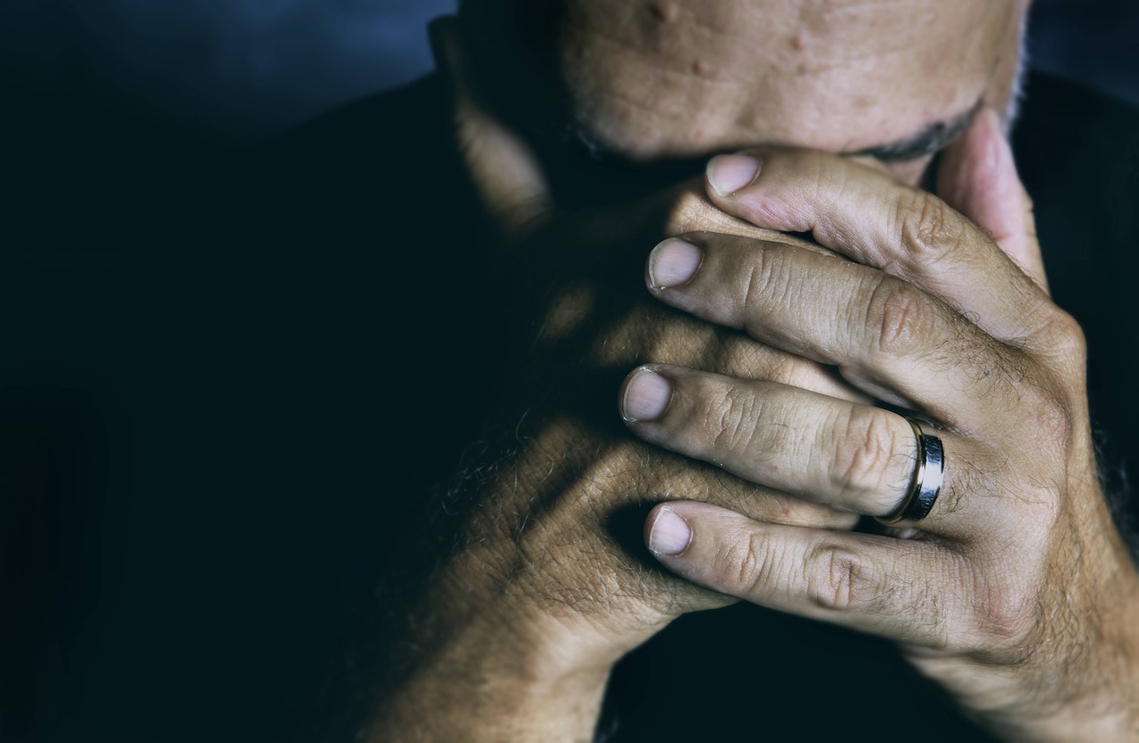 A Sad Man Covering his Face with his Hands | Veteran Car Donations
