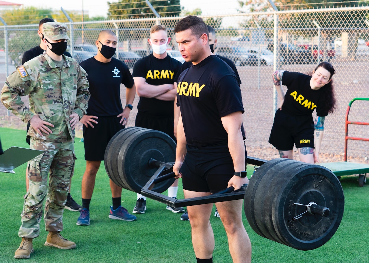 Men in Black Crew Neck T-shirt Holding Black Barbell | Veteran Car Donations