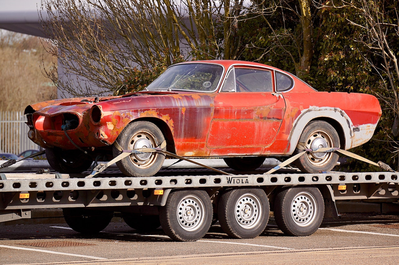 Red Coupe on Flatbed Trailer | Veteran Car Donations