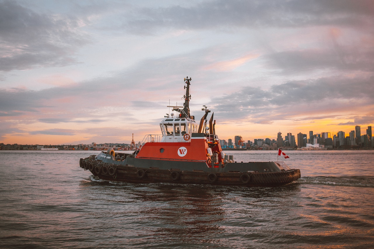 Tugboat sailing under bright sky | Veteran Car Donations