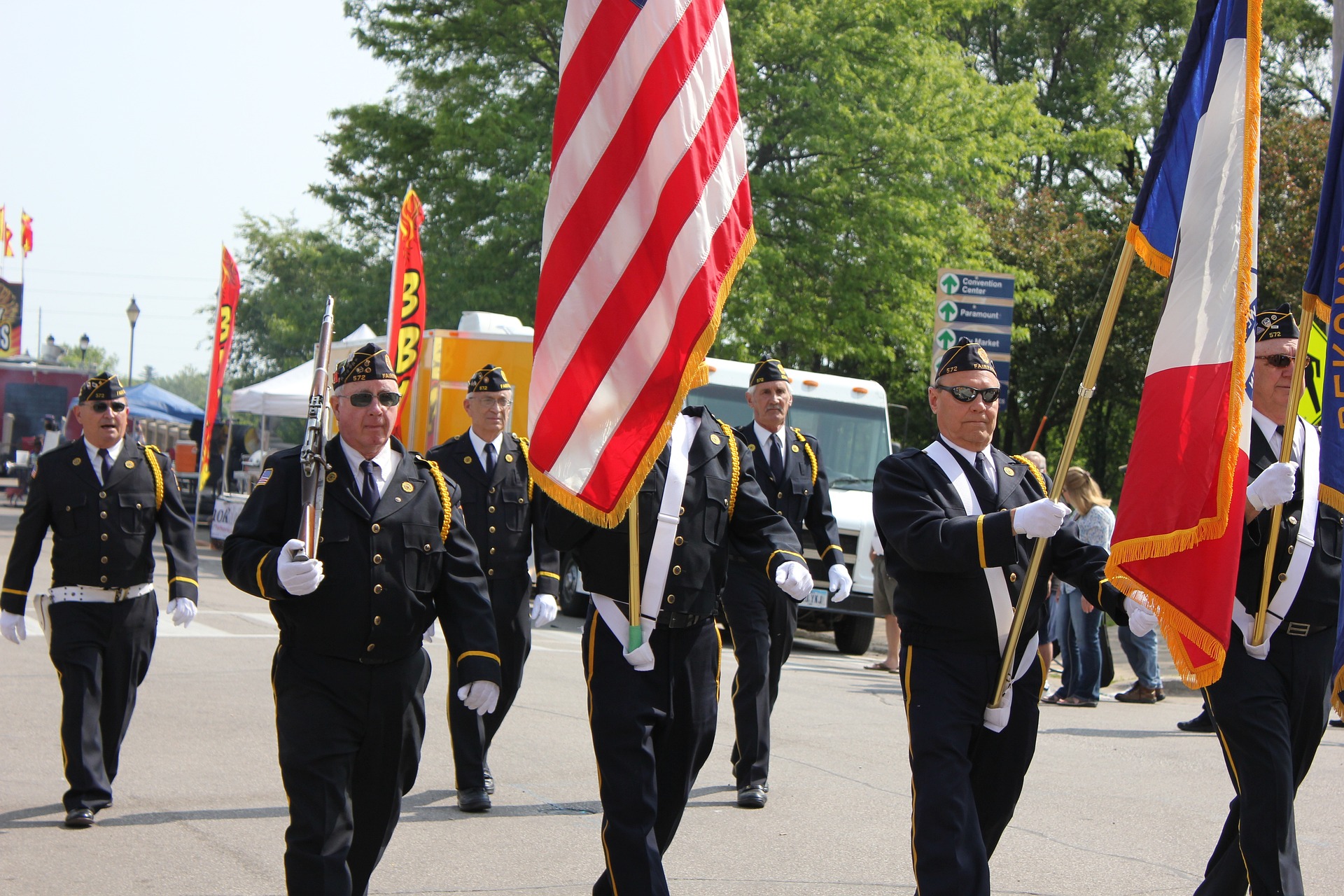 Veteran on Memorial Day holding flag | Veteran Car Donations