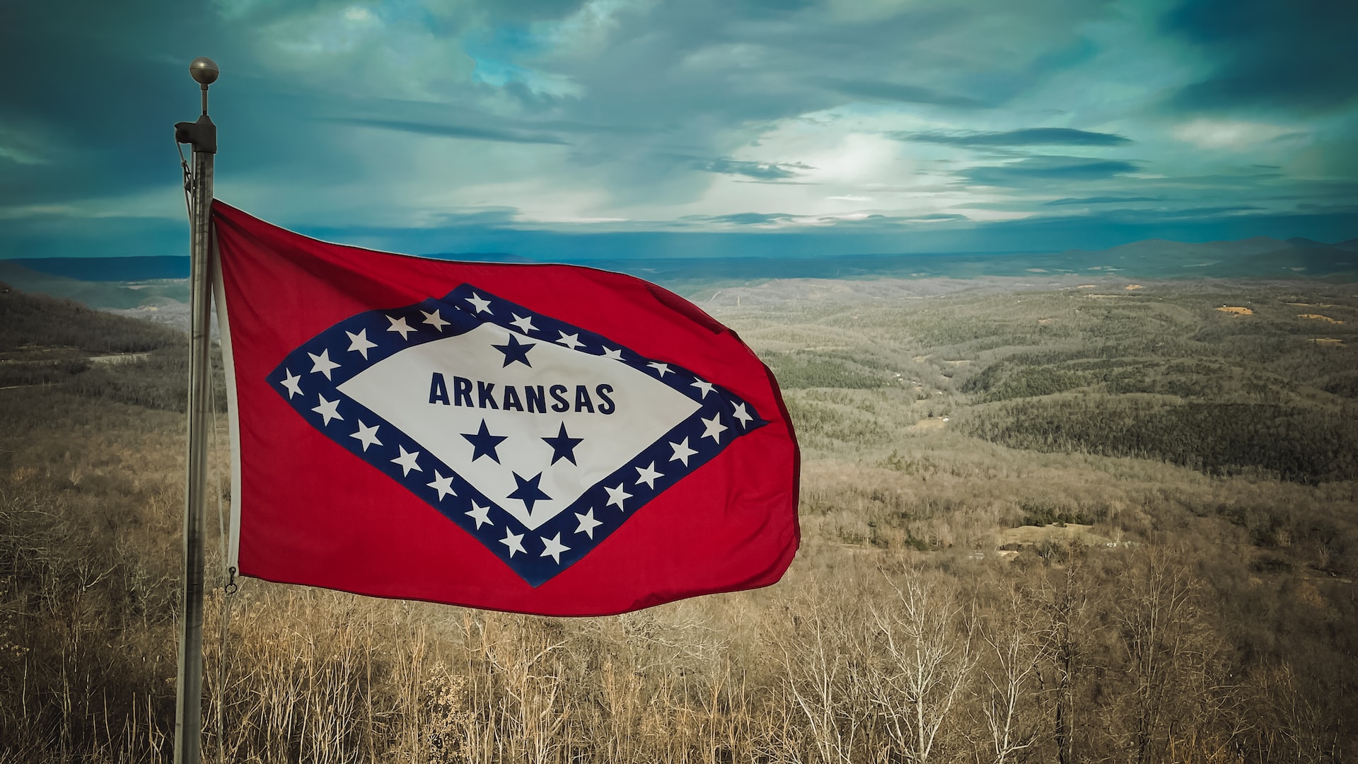 a flag in a field with a sky in the background photo | Veteran Car Donations