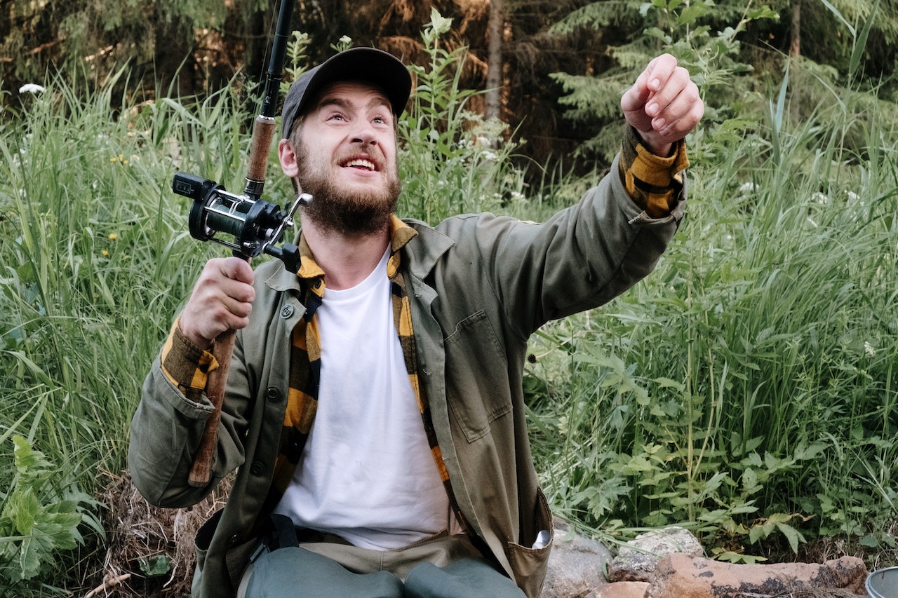 Man in Gray Jacket Holding Black and Brown Camera | Veteran Car Donations
