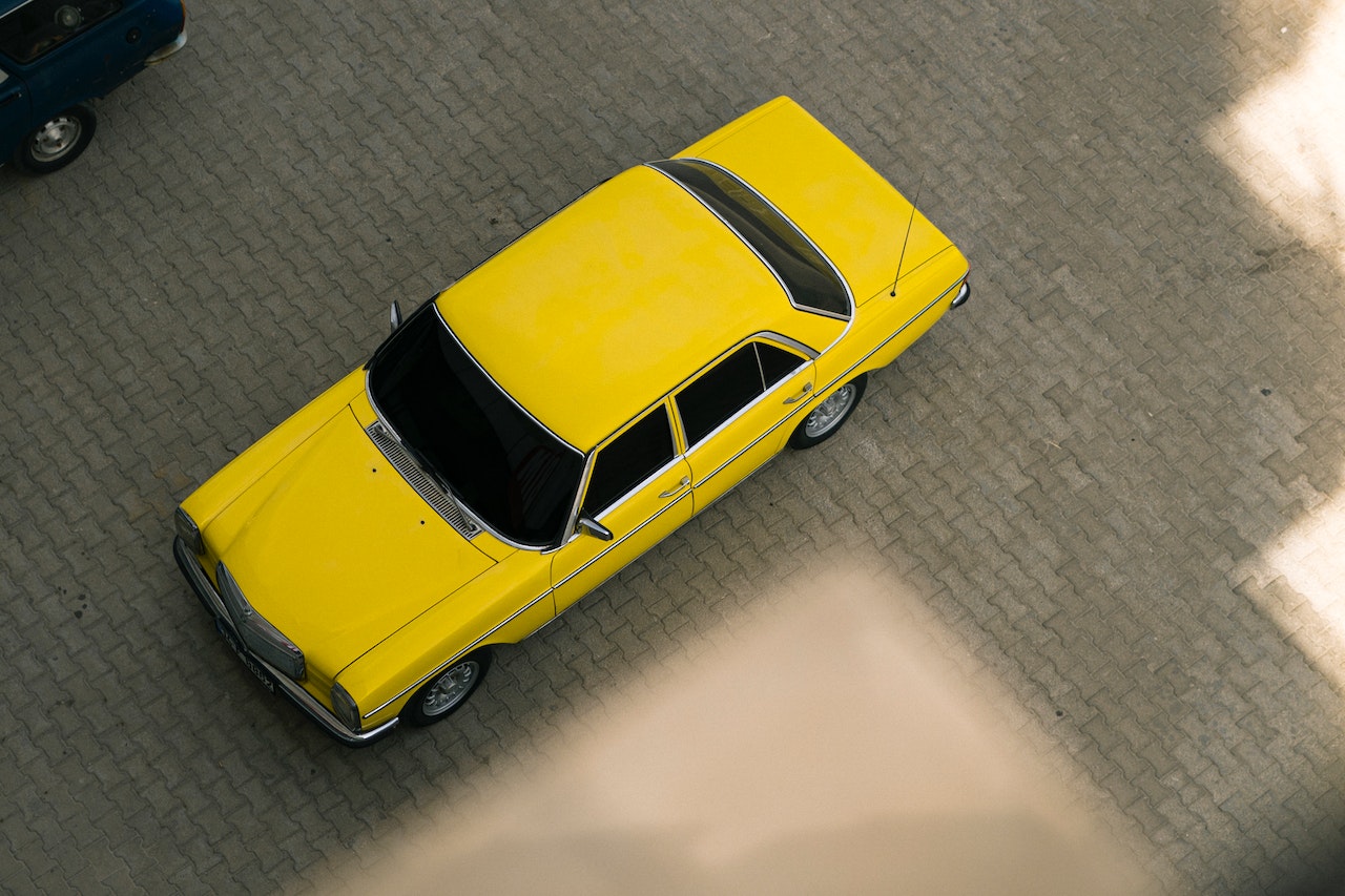 A Yellow Car on Paved Surface | Veteran Car Donations