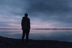 Alone Man Standing by the Lake | Veteran Car Donations