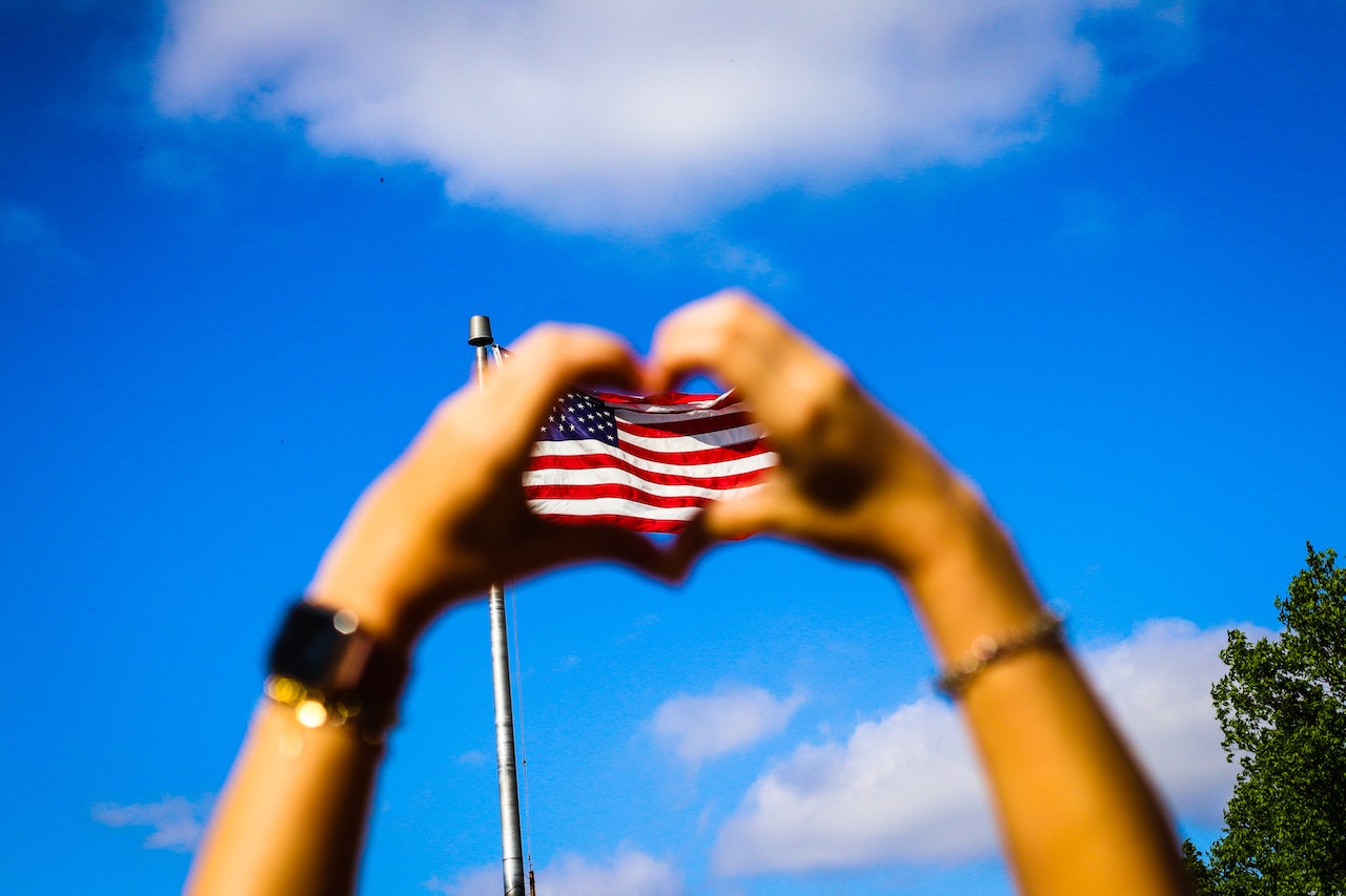 Human Hands and Us Flag | Veteran Car Donations
