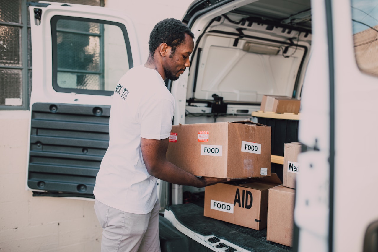 Man Placing Food | Veteran Car Donations
